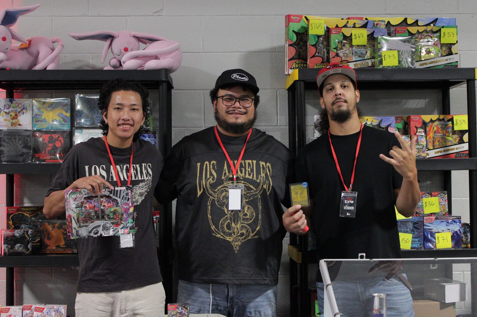 Vendors trading cards behind the display cases at the ATL Card Expo