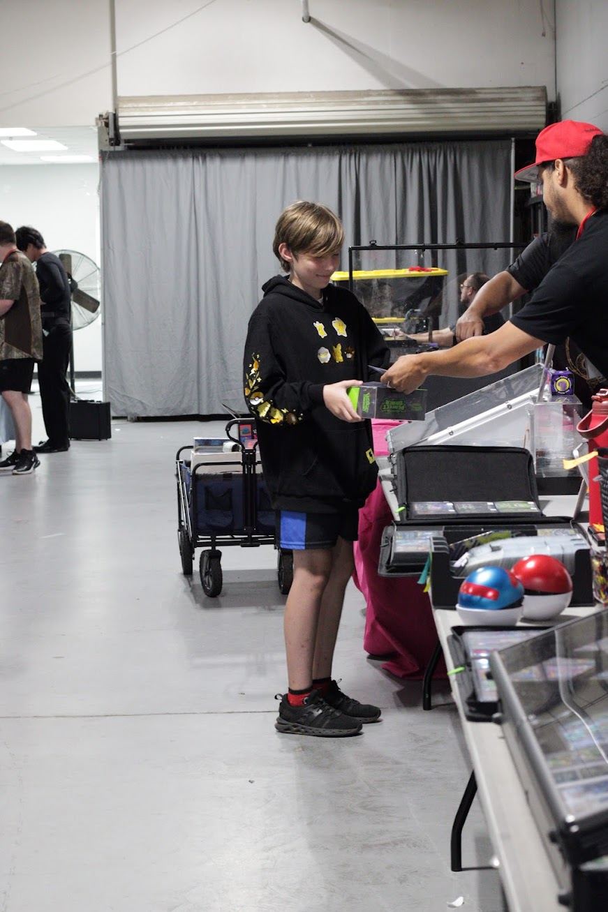 A young collector making a trade at a booth
