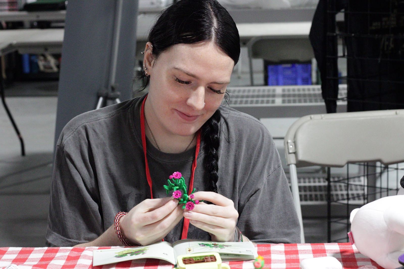 A vendor with handmade figures and a card binder