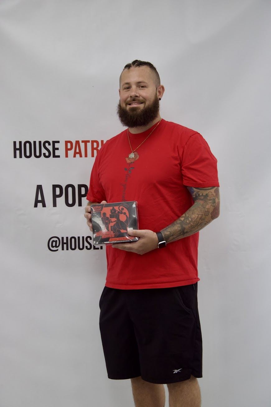 Giveaway winner holding a prize at the backdrop